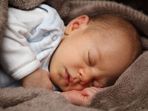 Baby sleeping wrapped in a blanket