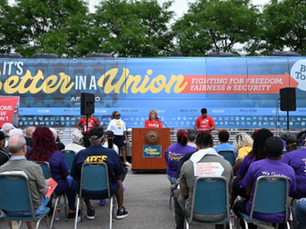 AFL-CIO rally with bus in back.
