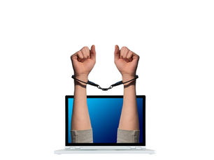 hands in handcuffs coming out of a computer