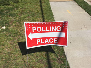 Polling place sign in grass.