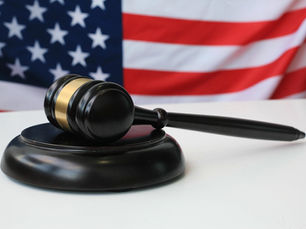 Judges gavel on a white table in front of american flag