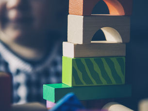 stacked blocks with child in background