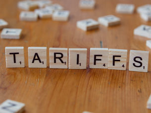 the word tariffs written in scrabble tiles