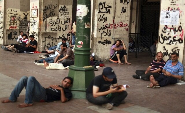 Arabic unemployed men lounge on the street