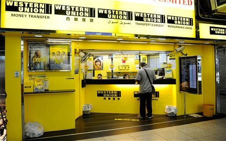 A man picks up a wire transfer at a Western Union branch in Lagos. (Creative Commons)