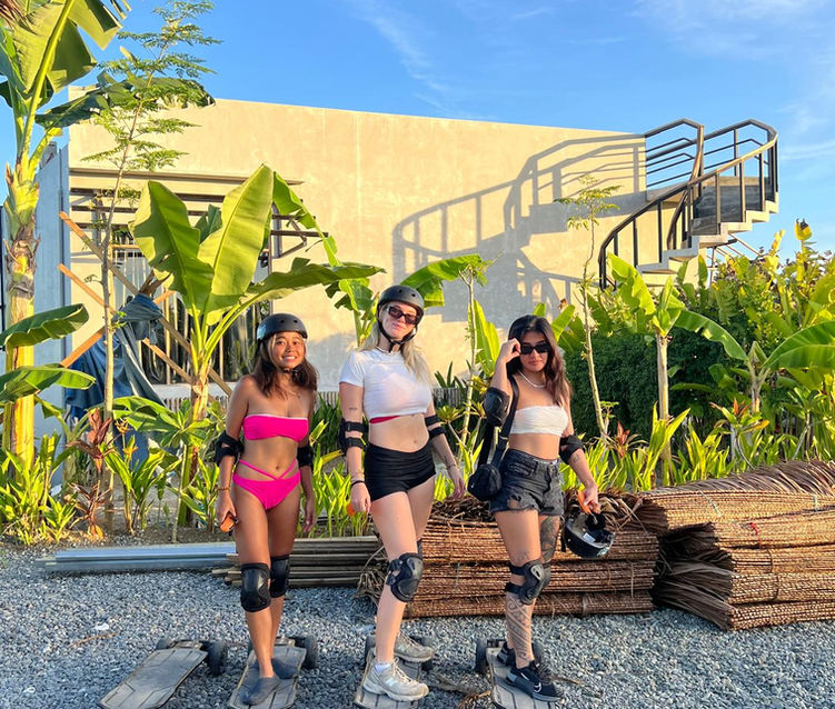 3 girls riding an electric skateboard in Siargao.