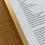 Thumbnail: Metallic gold frame edge of the framed poem 'western futility' by Naarm/Melbourne based intuitive naturopath and healer Aliesha Bannister. 