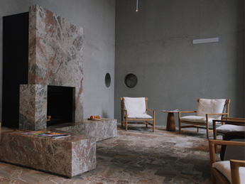 Lounge with chairs and a fire place.