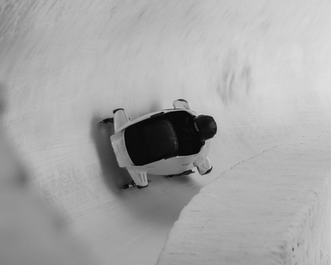 A bob sleigh on a bob track in a turn.