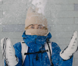 woman throwing snow into the air 
