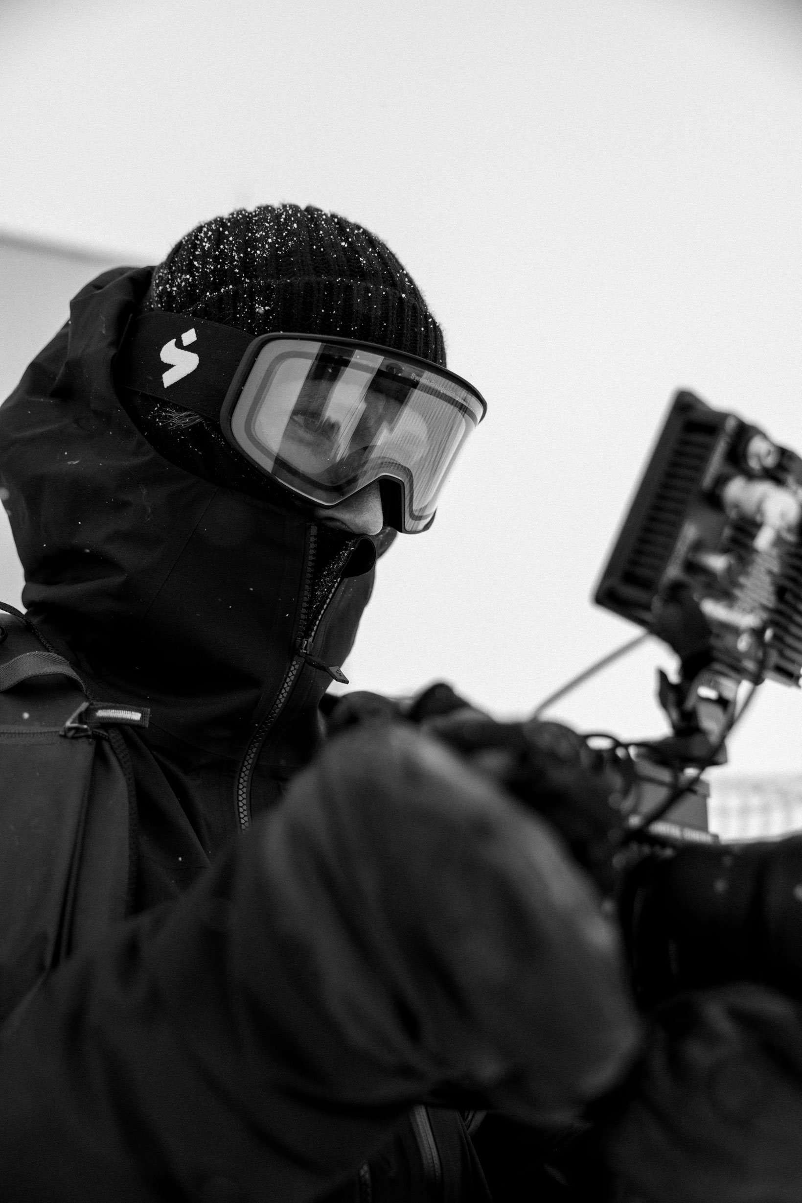 Fabian Gattlen looking at a screen of a film camera.