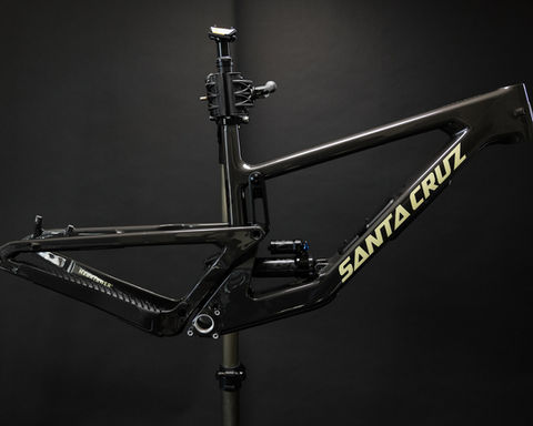 Moountain bike frame haning on a work stand