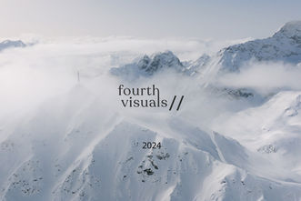 drone image of snowy peaks in the swiss alps