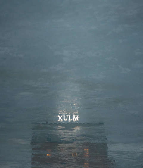 Reflection of a hotel on a ice patch.