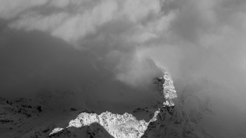 Mountain ridge above fog.
