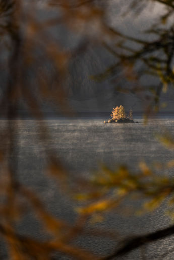 Small island on a lake in autumn colors.