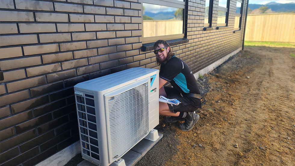 Mac Electrical’s Morgan installing a Daikin heat pump in Kāpiti.