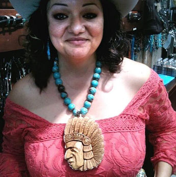 Woman wearing giant chief charm by Coreen Cordova Jewelry