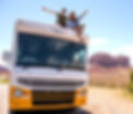 Two young people sitting on top of an RV