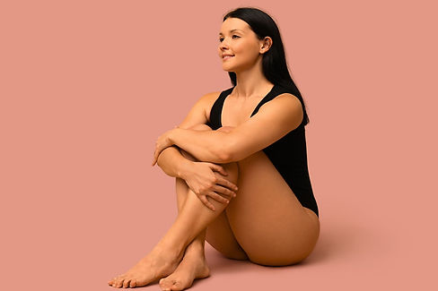 Tan woman wearing black unitard to show her tan - for Glow Luxe Spray Tans