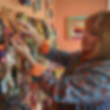 Coreen Cordova showing her collection of international folk art silver bezel pendant charm