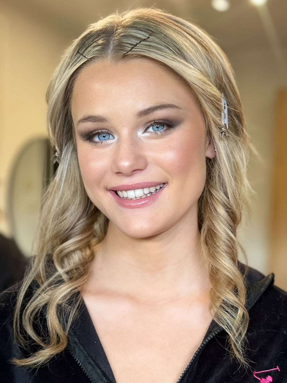 Smiling blonde portrait with soft braids and natural glam