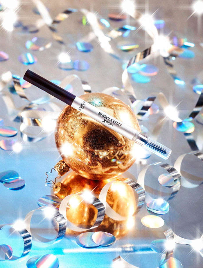 eyebrow pencil on Christmas bauble in dico setting and confetti