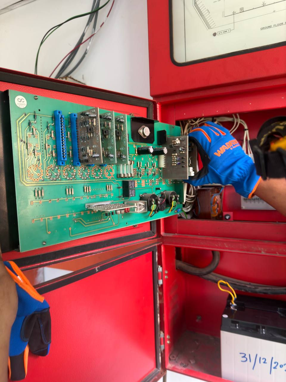 Technician performing maintenance on a fire protection system control panel, ensuring optimal functionality and safety.