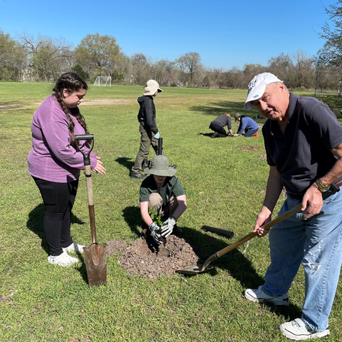 People using shovels breaking ground