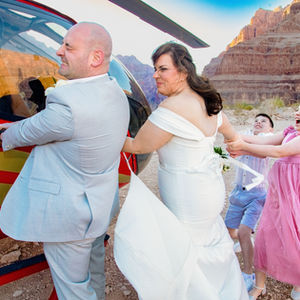 Group posing beside a helicopter during a Grand Canyon photo experience