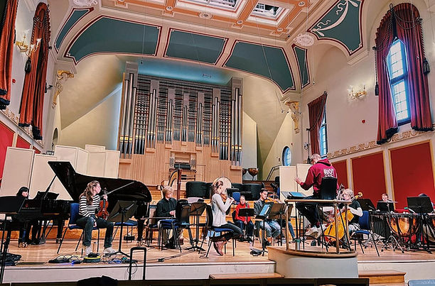 Large concert venue photo of orchestra on stage
