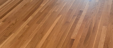 Oil-based hardwood floor finish with a warm amber tone