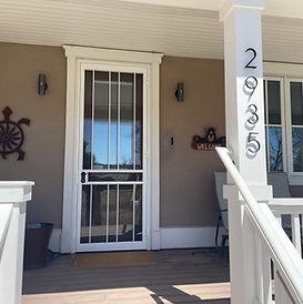 traditional white security screen door on porch