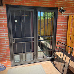Patio security storm door set with a small pet door to the side