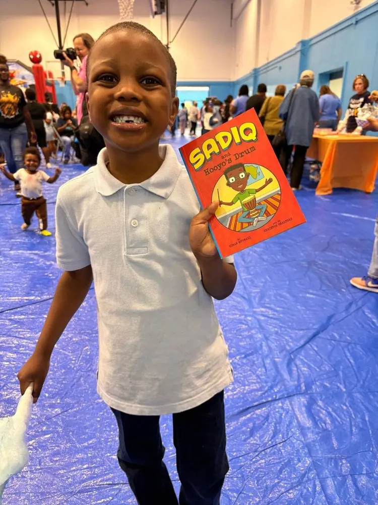 A boy showing off his new book