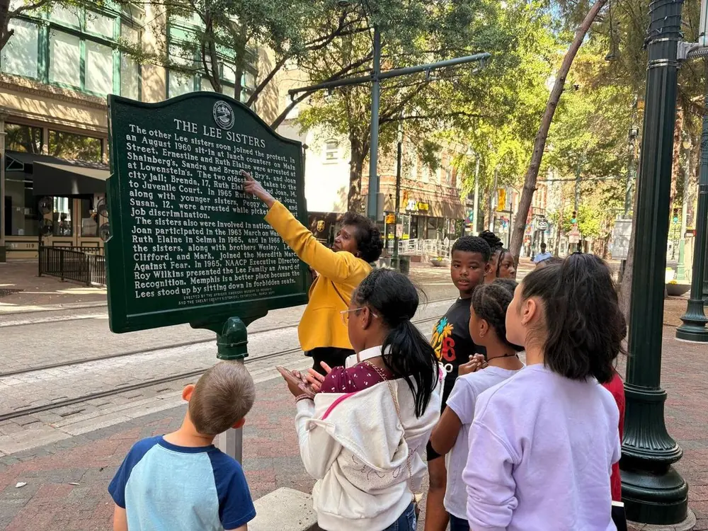 Students reading a Memphis historical marker downtown