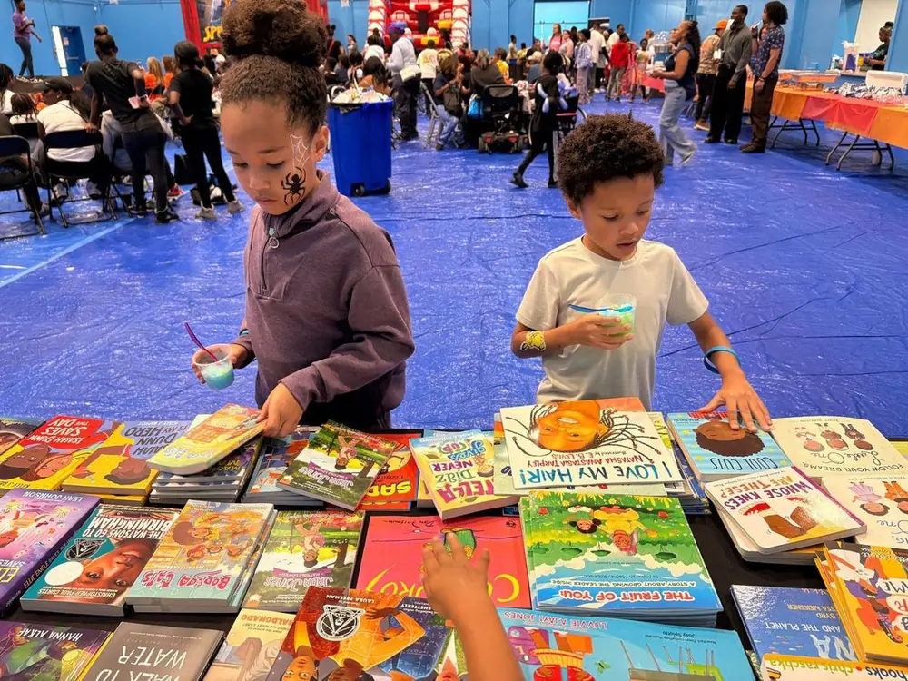 Children choosing books from a table