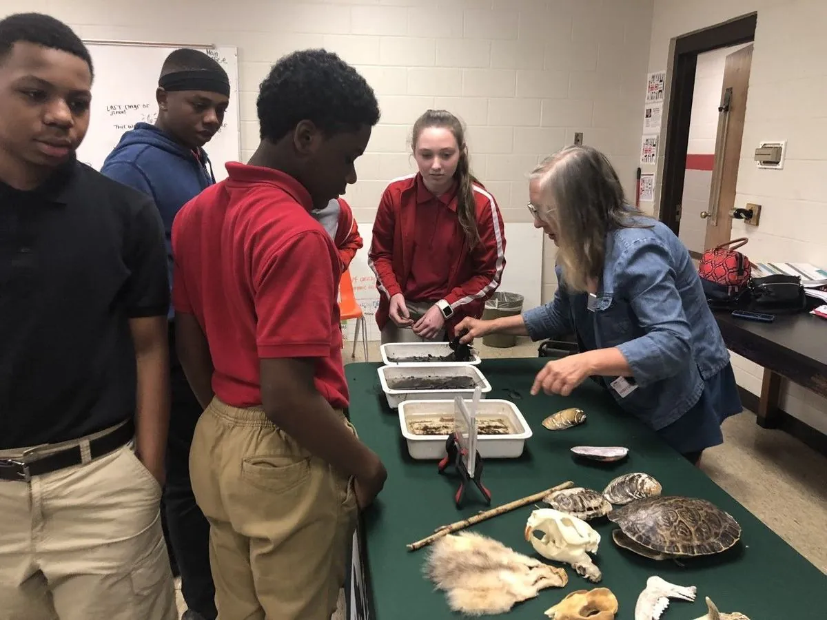Students studying artifacts at a table