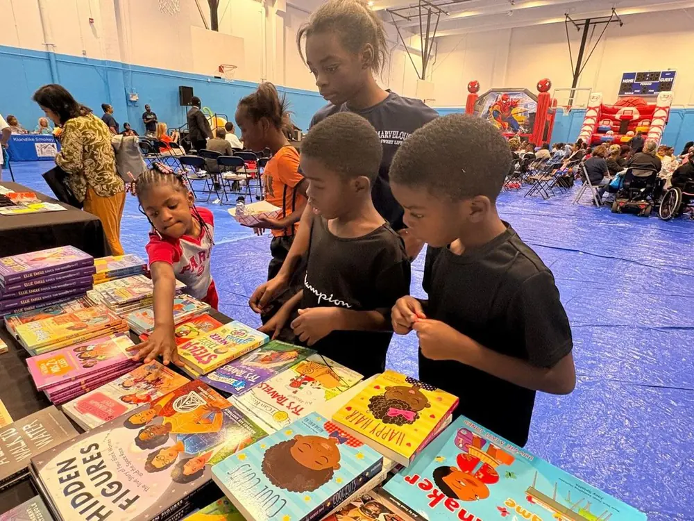Children choosing new books at a community festival