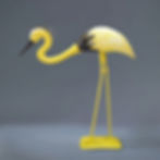 Thumbnail: Handcrafted yellow crane garden statue with a minimalist gray background.