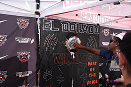 A member of El Dorado High School football team gets a pie to the face in the group's fundraising booth during the 2025 Artisan Market.