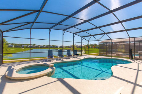 Orlando vacation rental home with private screened pool and spa and a water view.