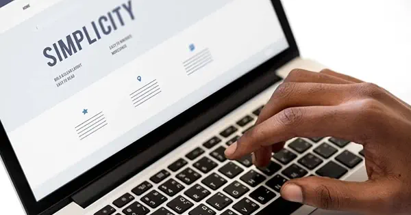 laptop open showing the word simplicity on the screen