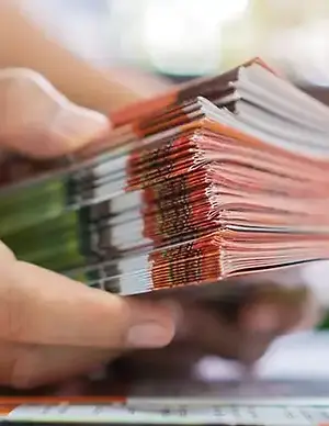 person holding brochures