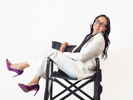 Woman in a white pinstripe suit and purple heels laughing during a personal branding photography session at Studio S Portraits in Needham, MA