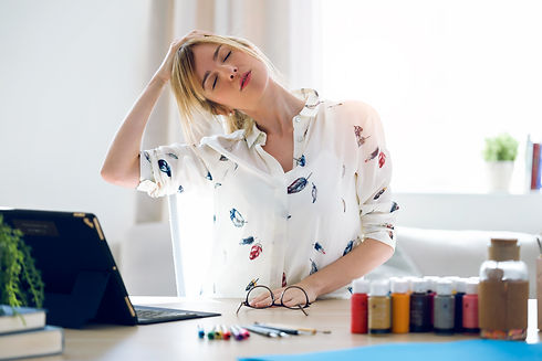 Woman stretching her neck at her desk