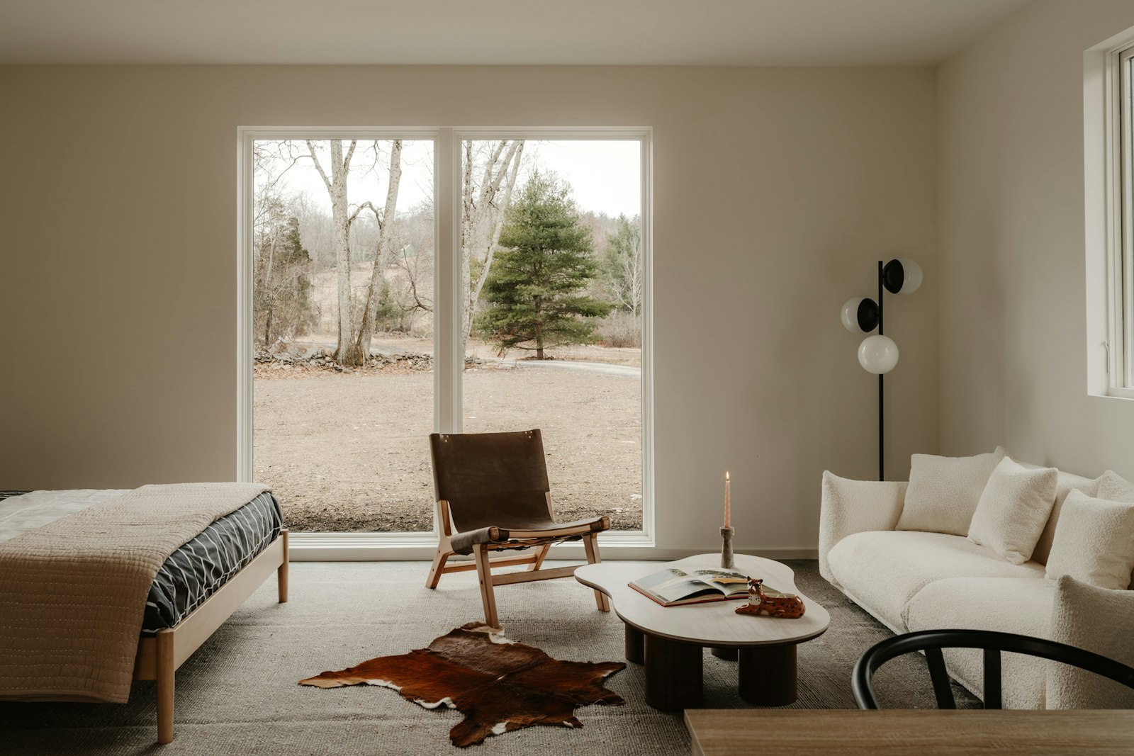 Bedroom and sofa by a window, no faces