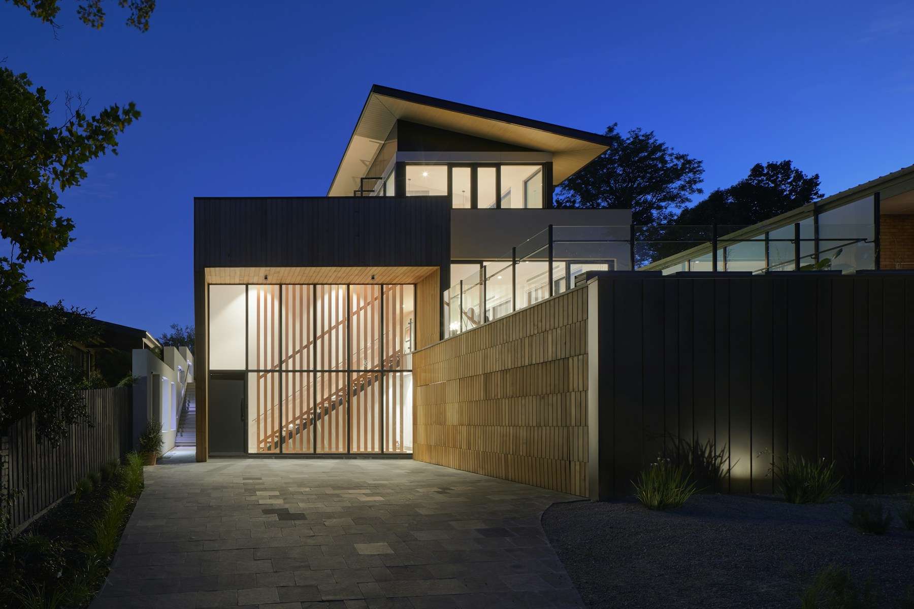 Two-story rental house lit at dusk