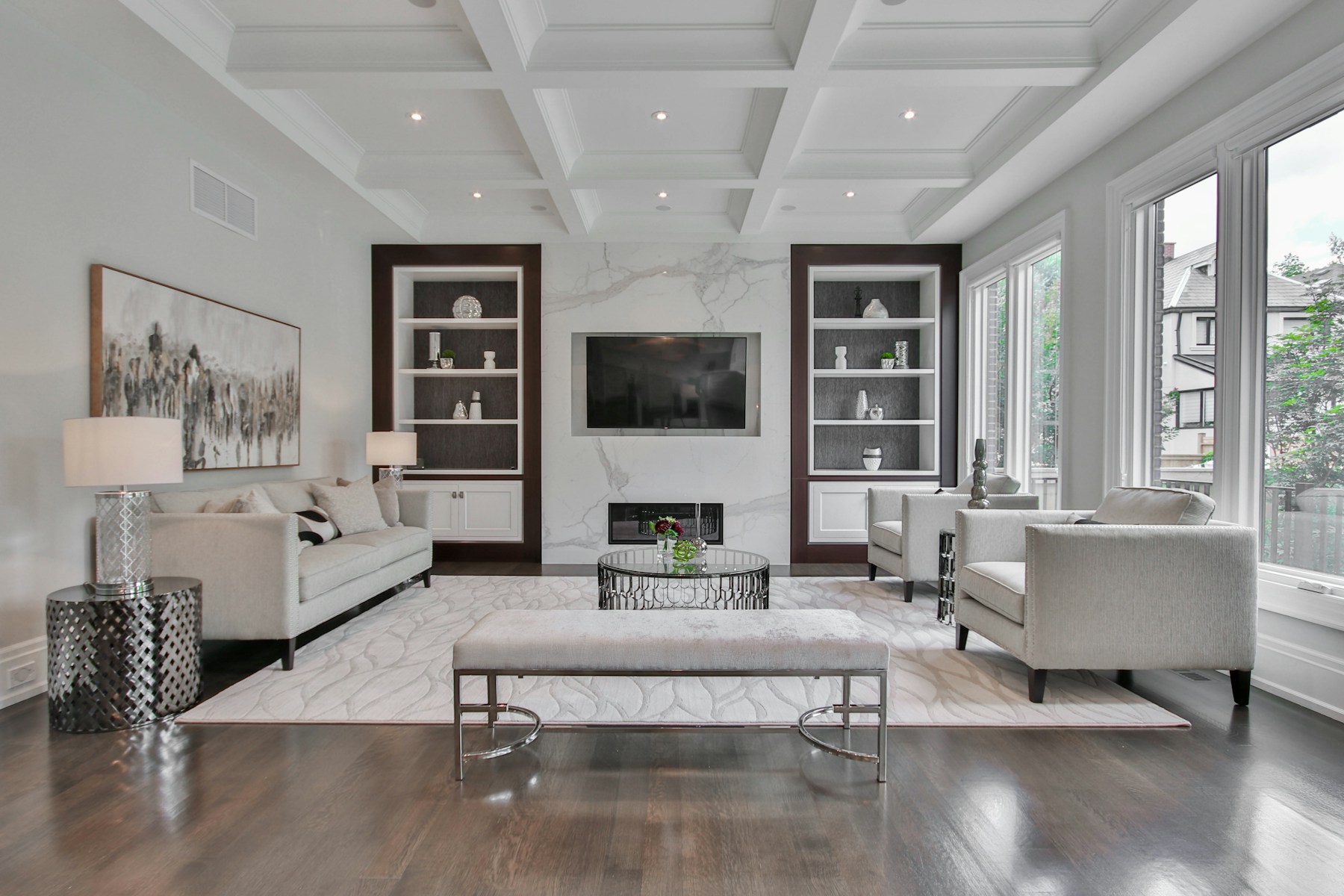 Formal living room with a coffered ceiling and marble fireplace