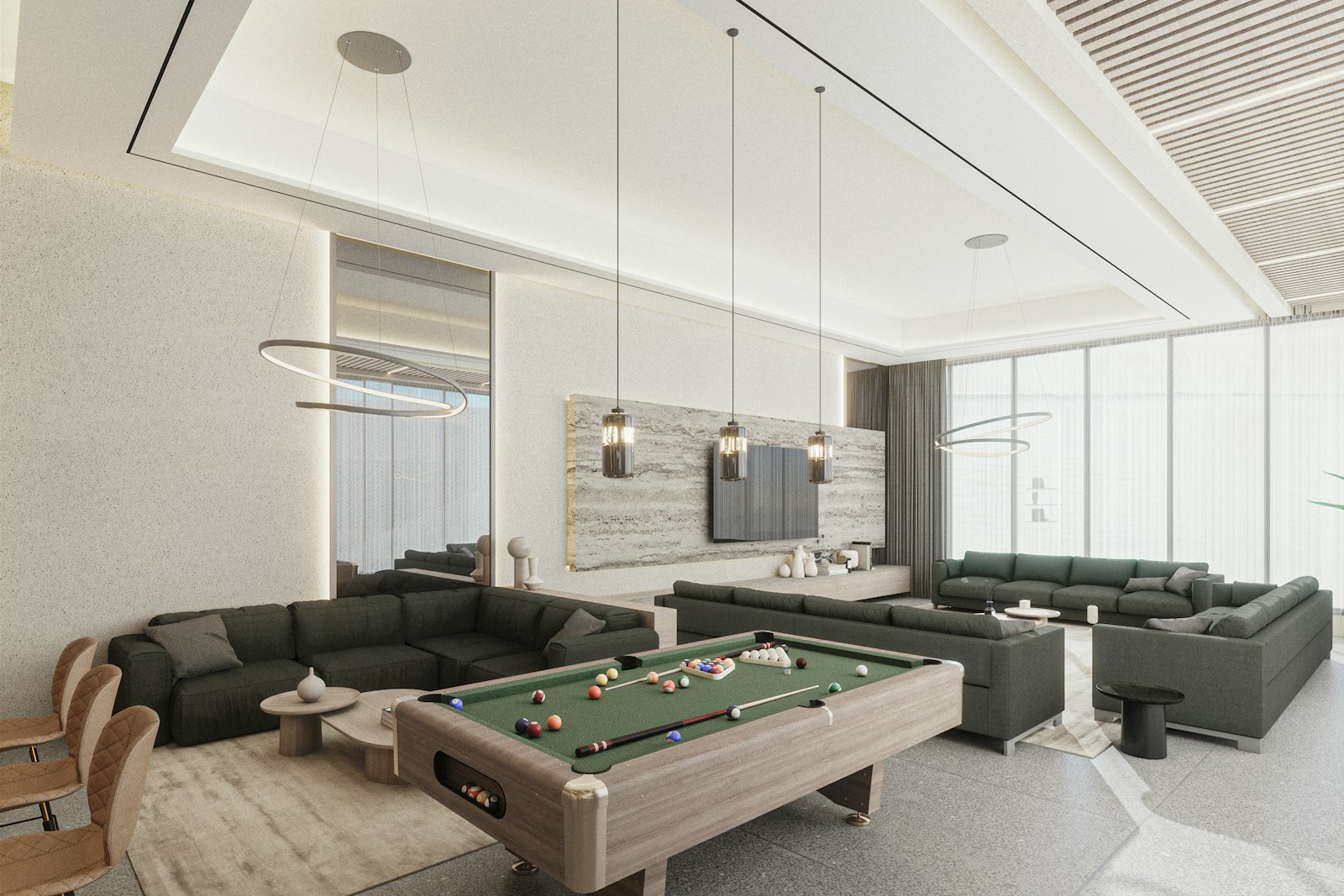 Large living room with sectionals and a pool table, no people